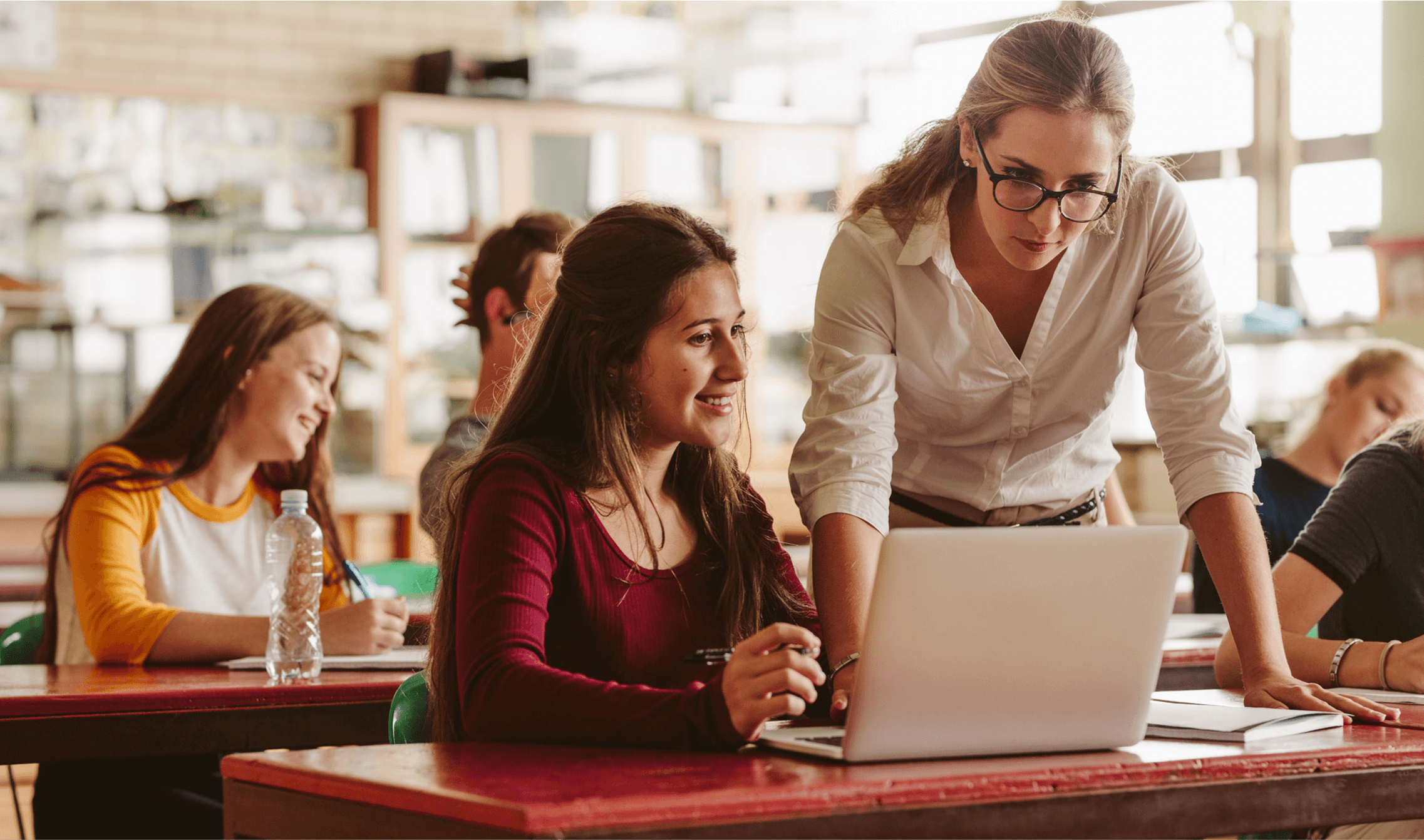 Professional mentor working with a high school student on a project